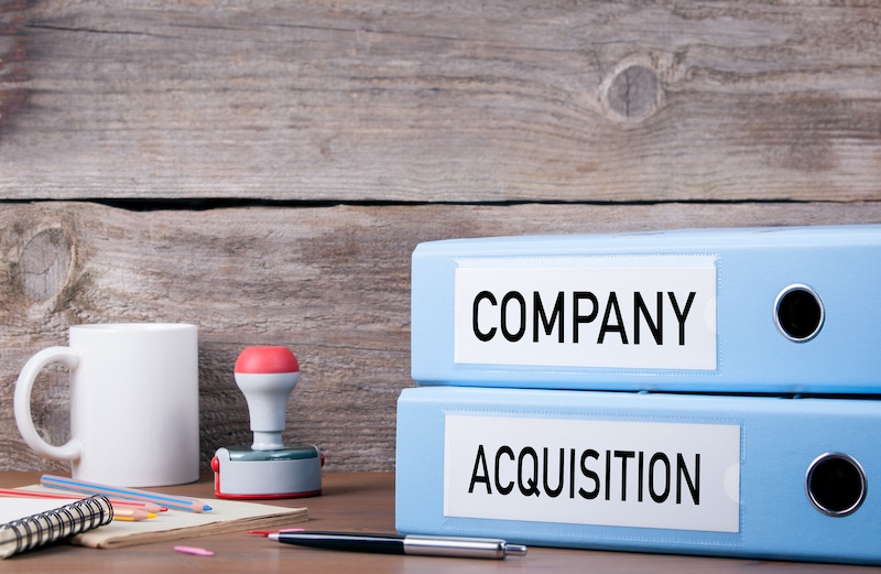 Company and Acquisition. Two binders on desk in the office. Business background