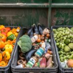 Avery Dennison UN International Day of Zero Waste Food waste and loss. Bins full of discarded fruits and vegetables. Concept of sustainability, food security, and environmental impact.